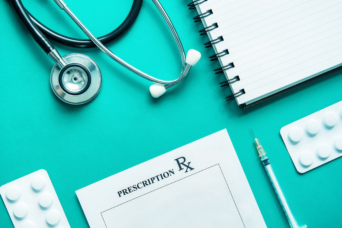 A stethoscope, a notebook and a prescription pad
